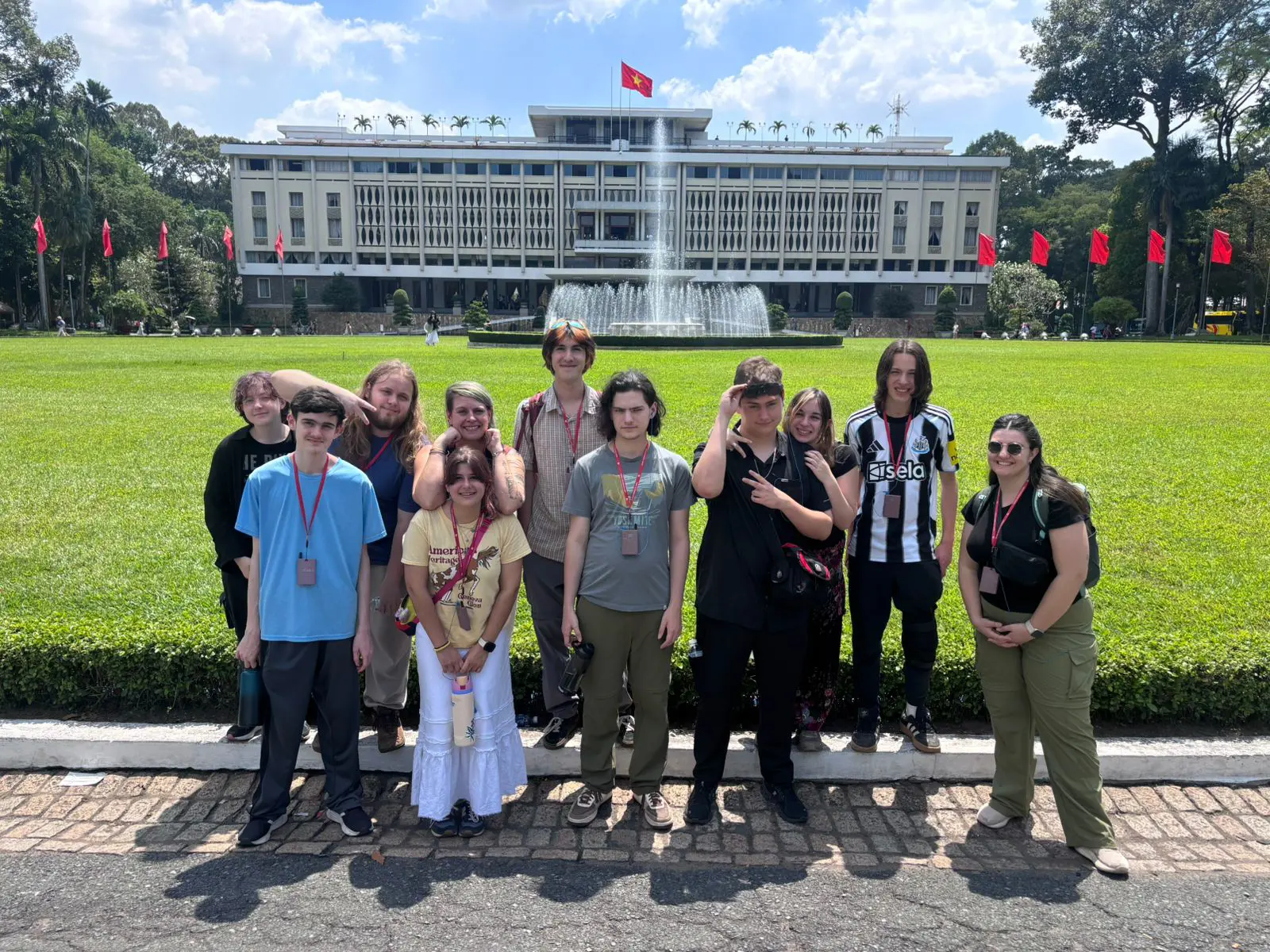 high school students posing together in front of a fountain and government building during an international travel program.