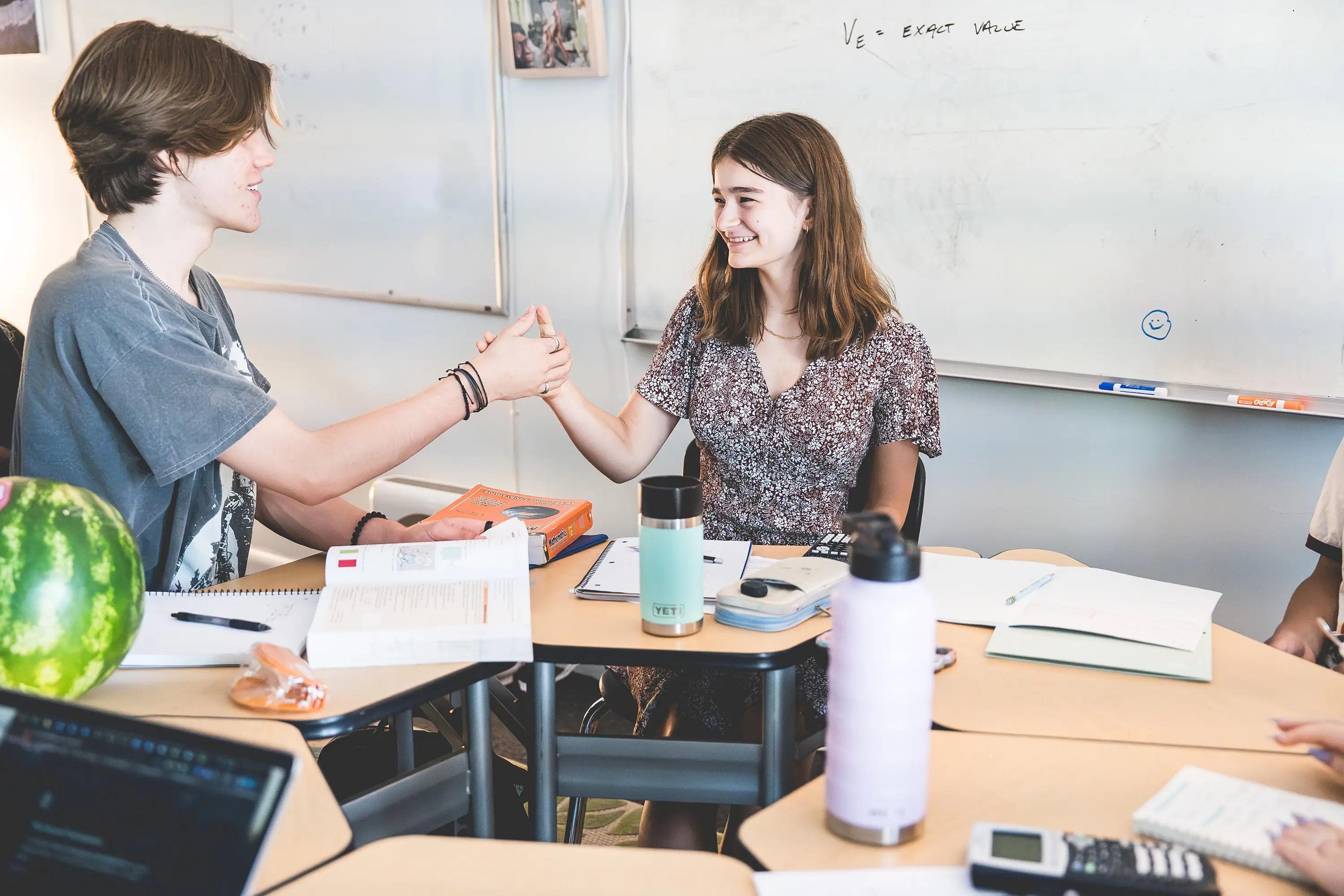 High school students are having a thumb war in Advisory.