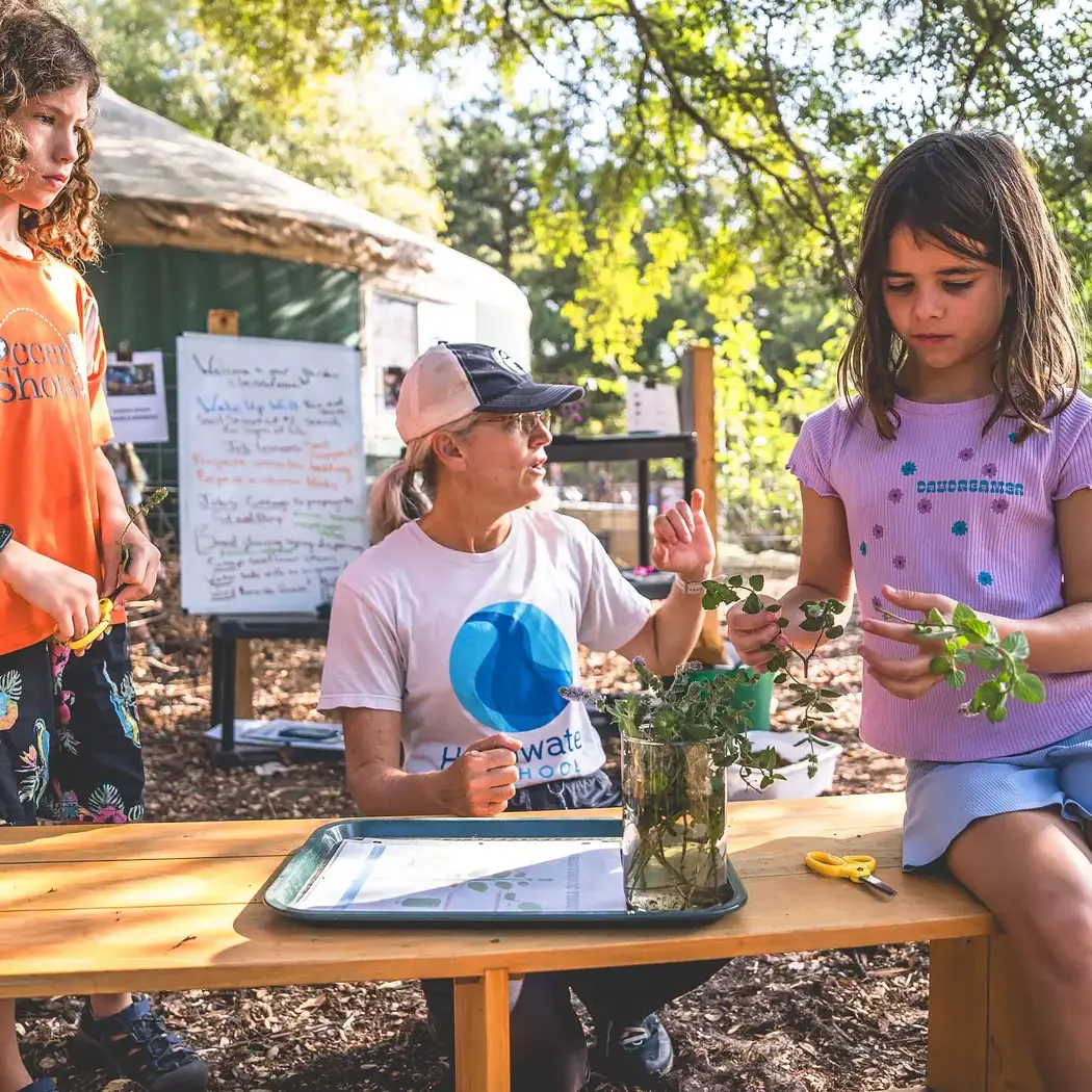 Elementary student learning about plats in a lesson with gardening guide Lucille.