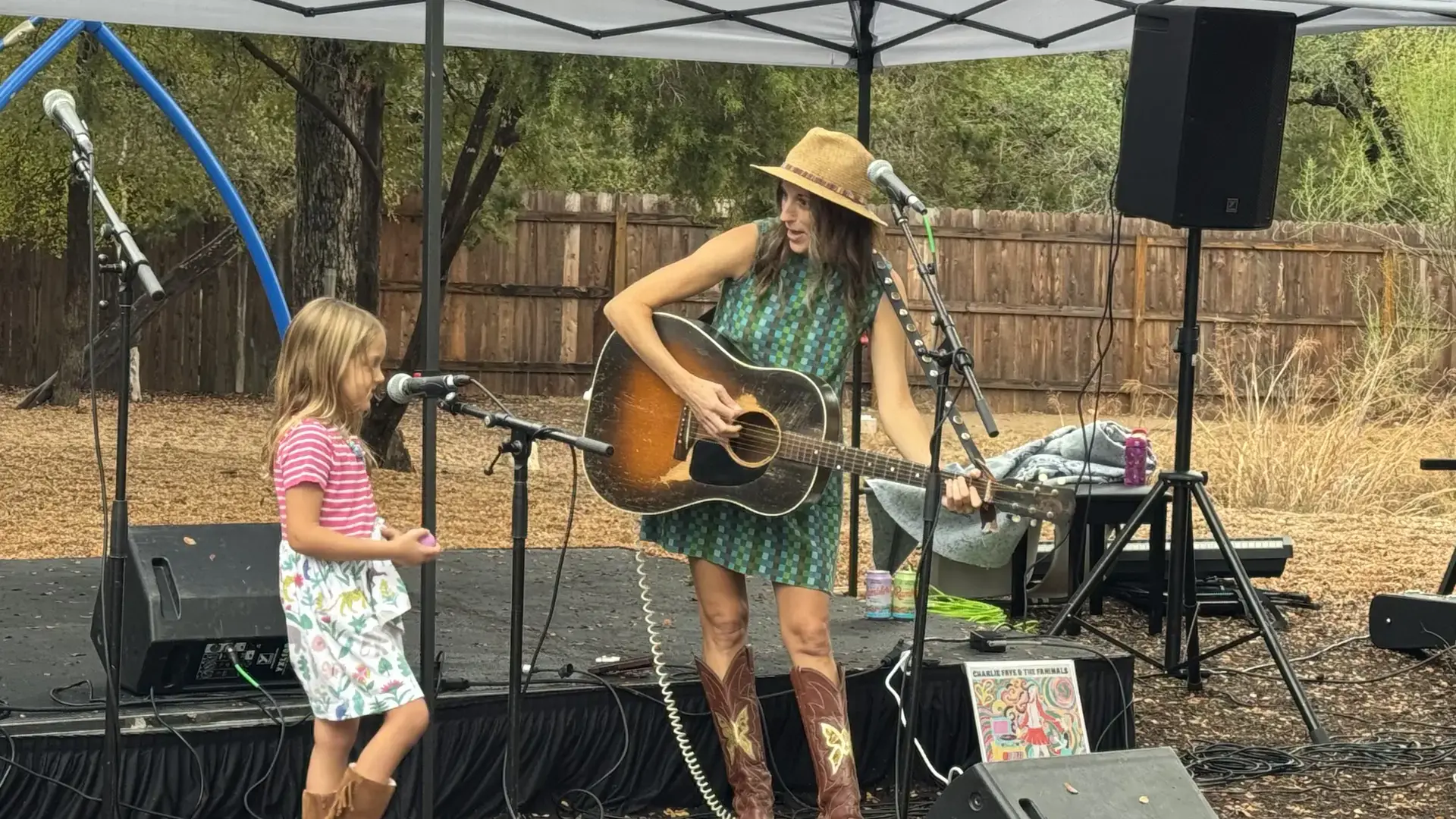 hild watching a musician play guitar on stage at the Headwaters Fall Fest.