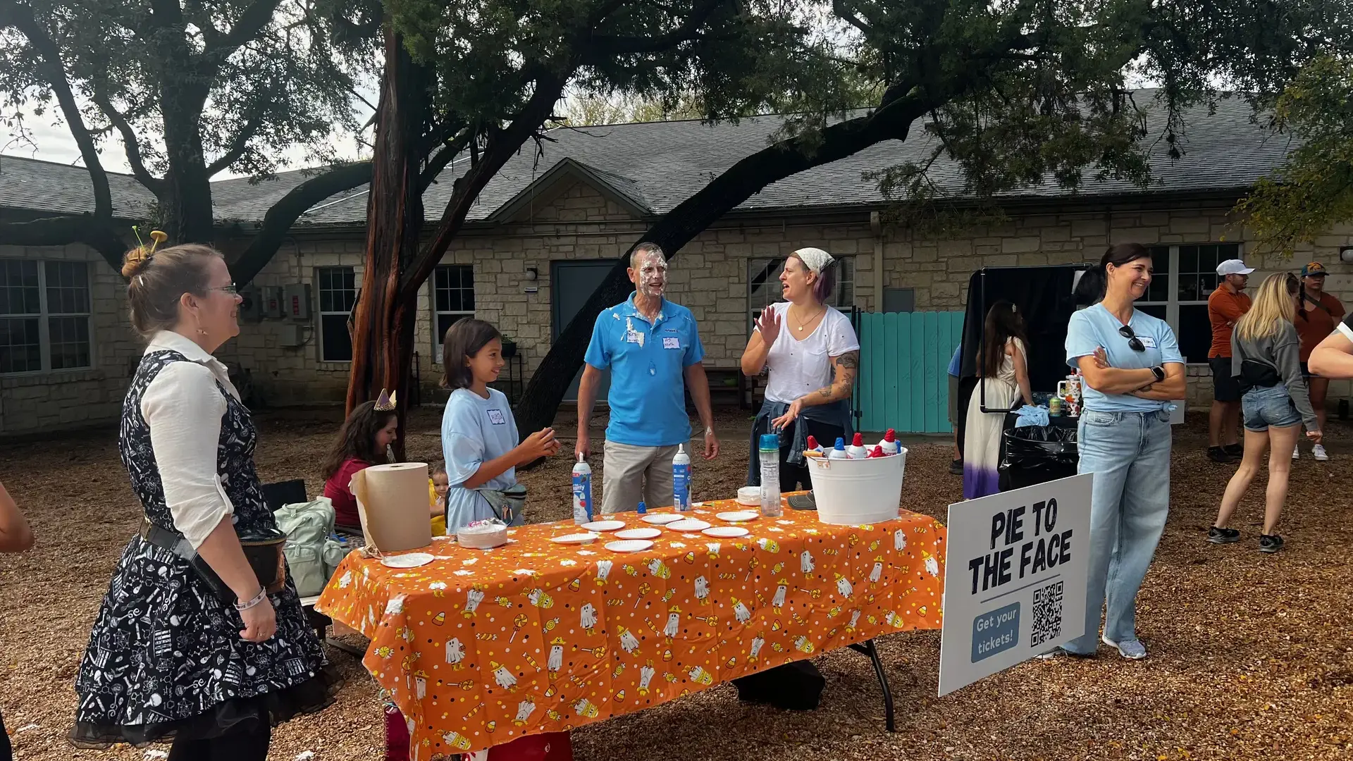 families gathered around a table for a pie-in-the-face game at the Headwaters Fall Fest.