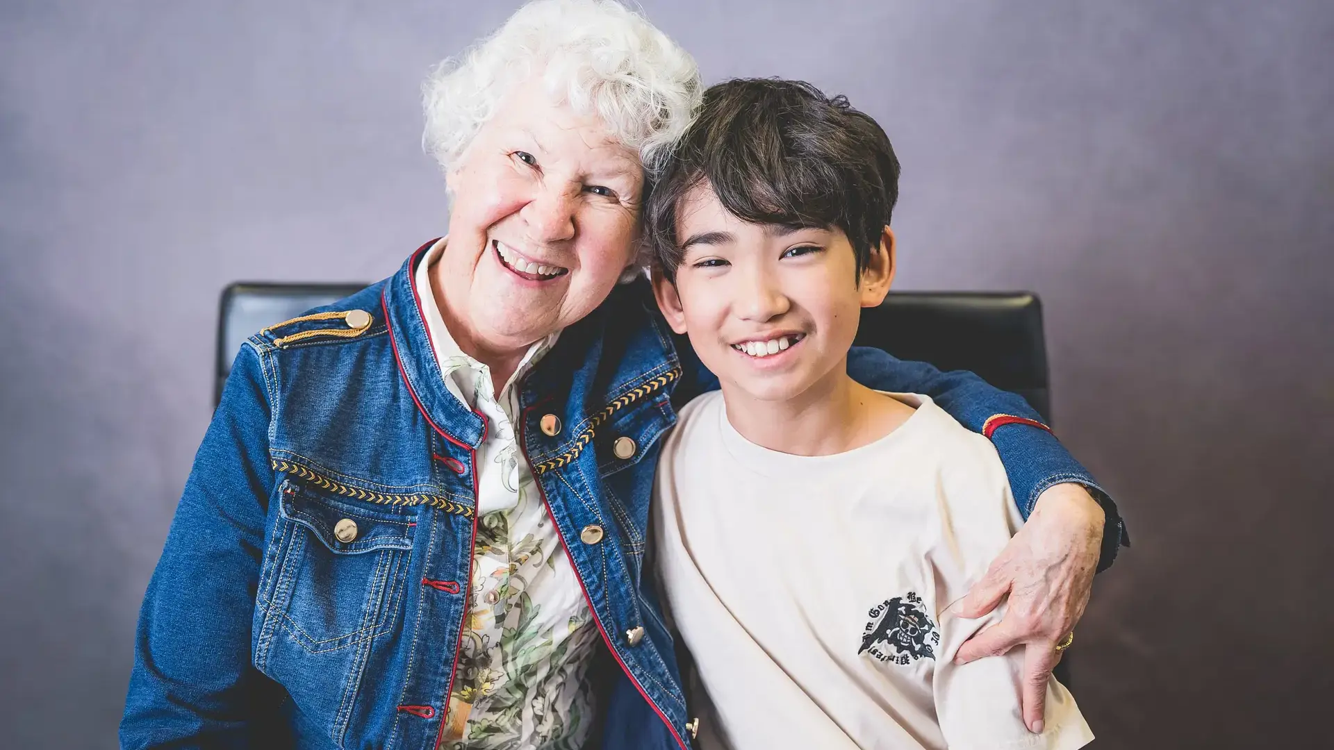student posing together with a grandparent.
