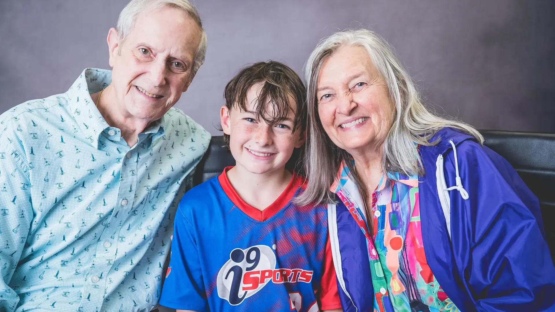 student posing together with grandparents during Grandparents and Special Friends Day.