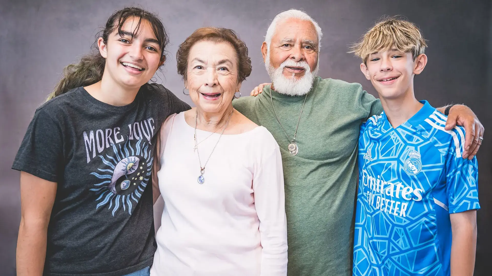 students posing together with a grandparent during Grandparents and Special Friends Day.