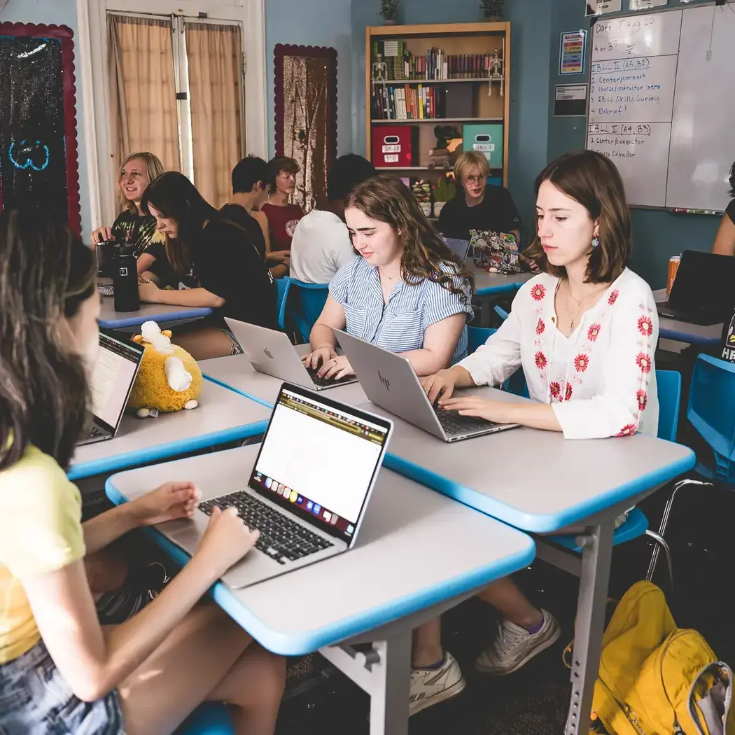 Headwaters high school students work independently and collaboratively on laptops during class at the River Campus.