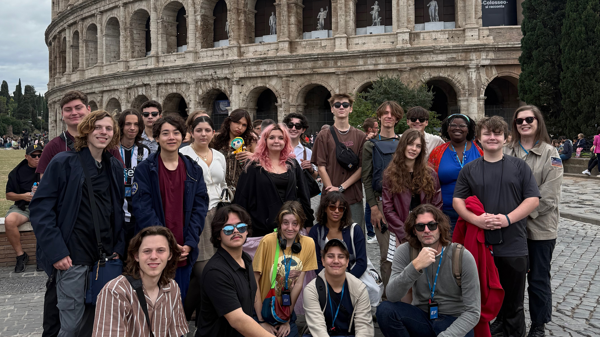 high school students posing together in front of a historic landmark during an international travel program.