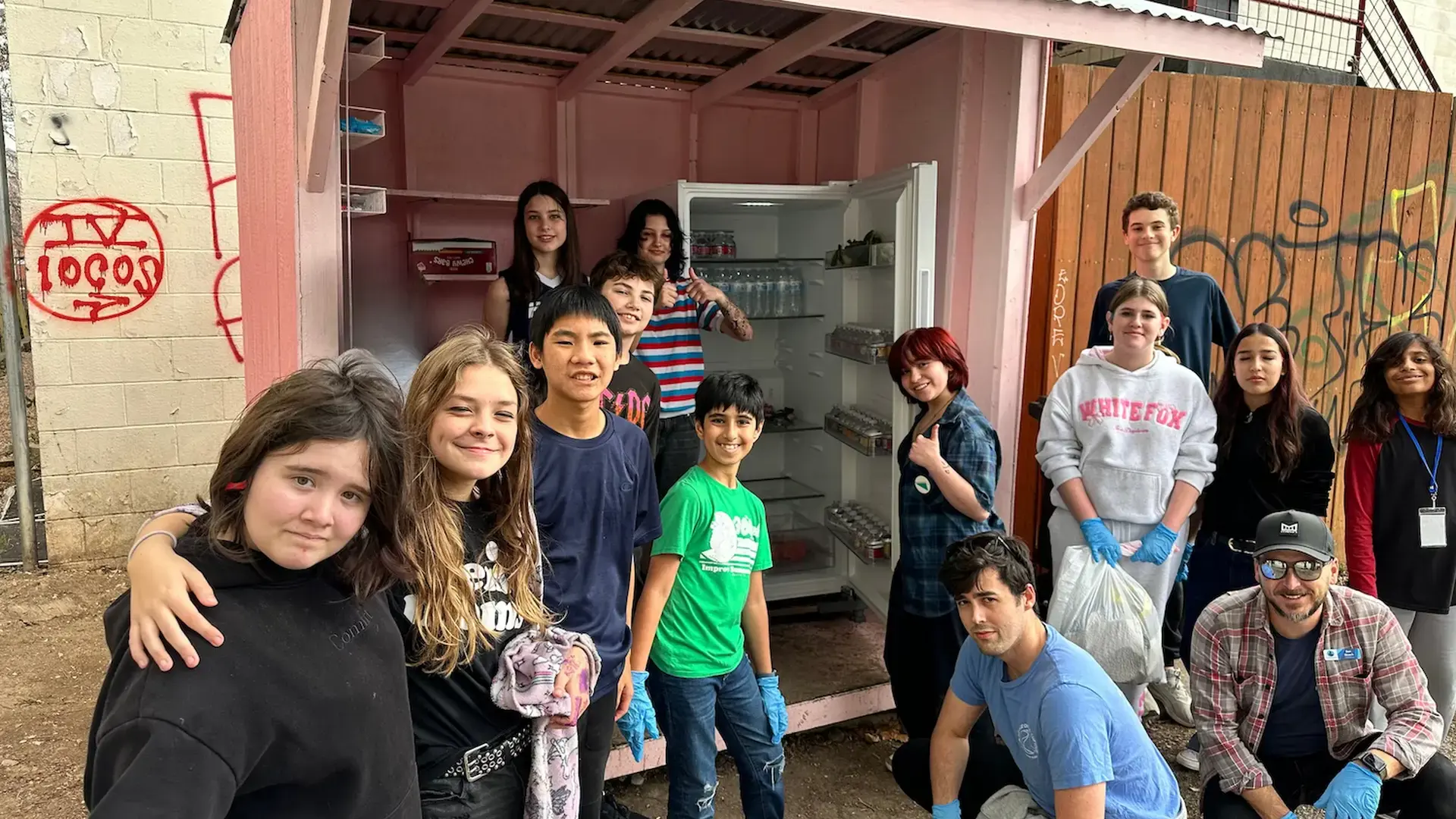 middle and high school students posing together with staff during an advisory service activity.