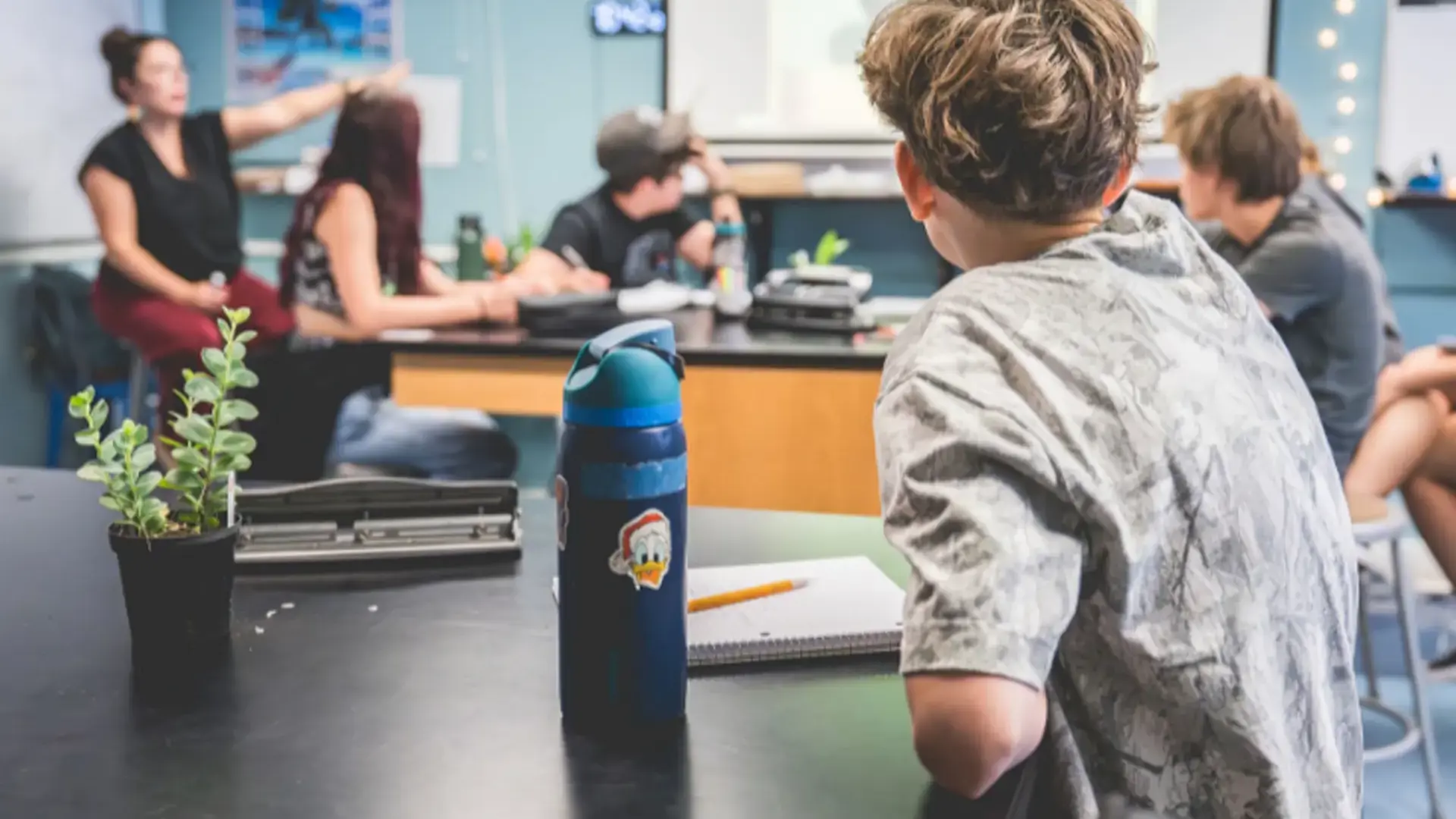 Middle school students working together in a science classroom.