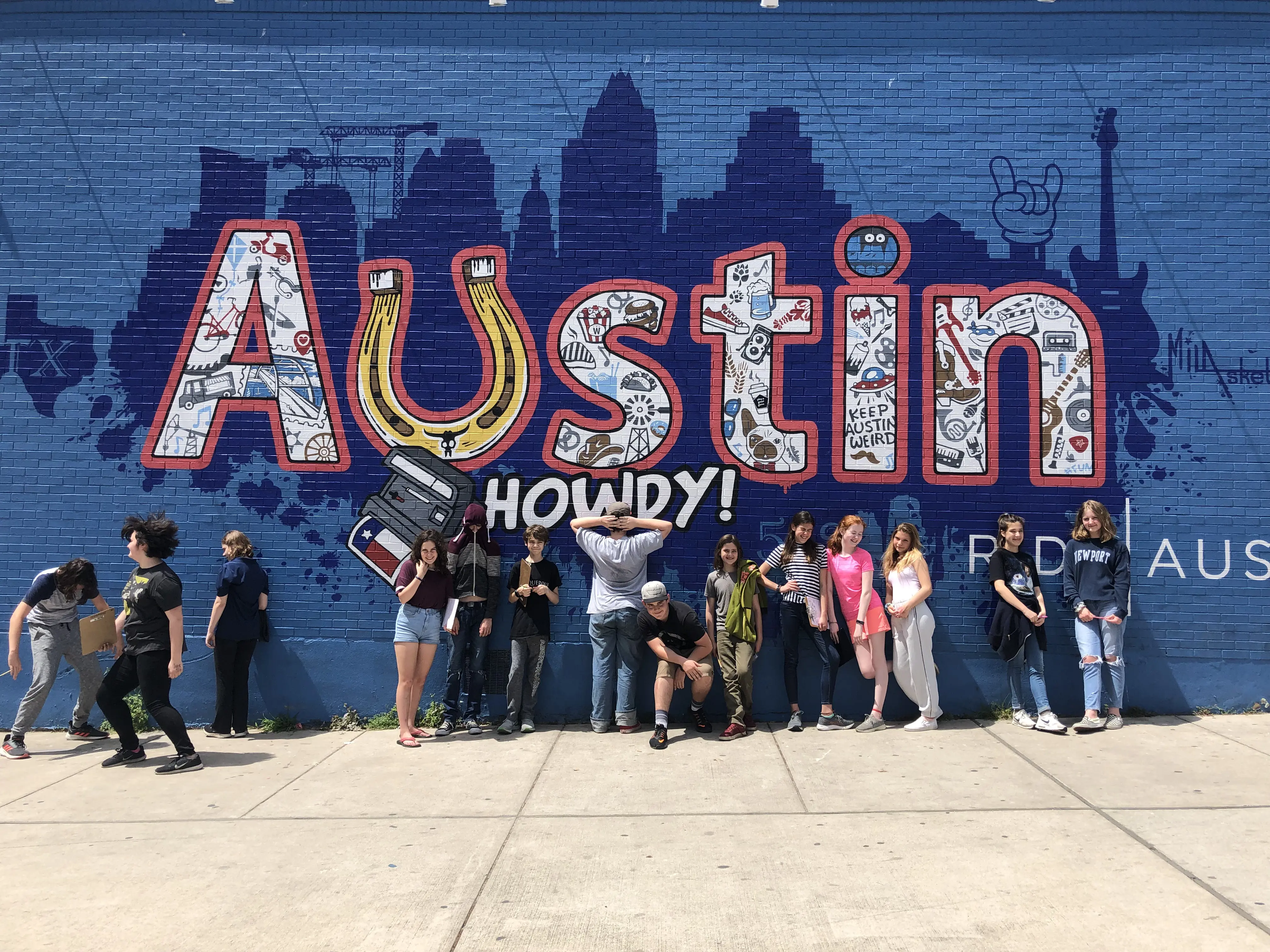 Headwaters Middle School students stand in front of an Austin mural during a city-based field study as part of the City as Classroom program.