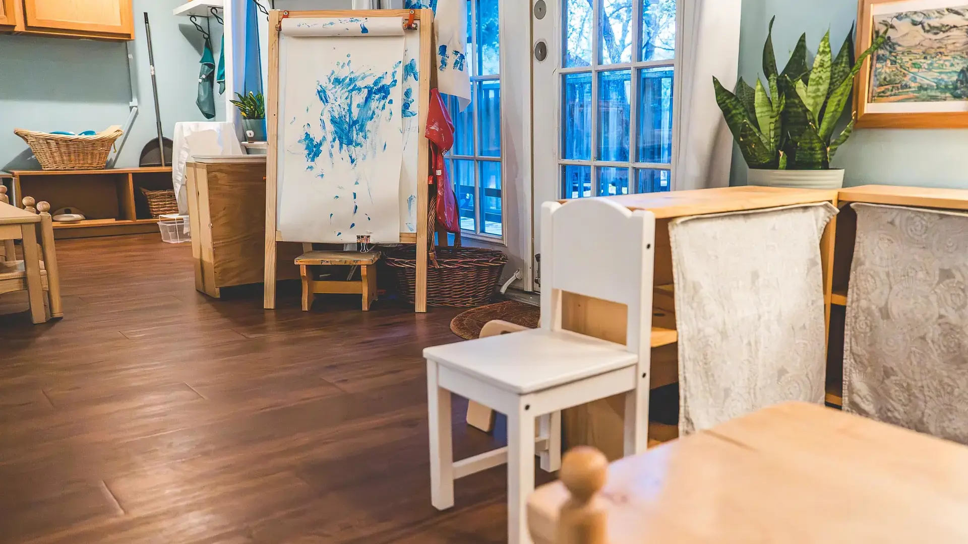 Montessori classroom with wooden chairs and tables.