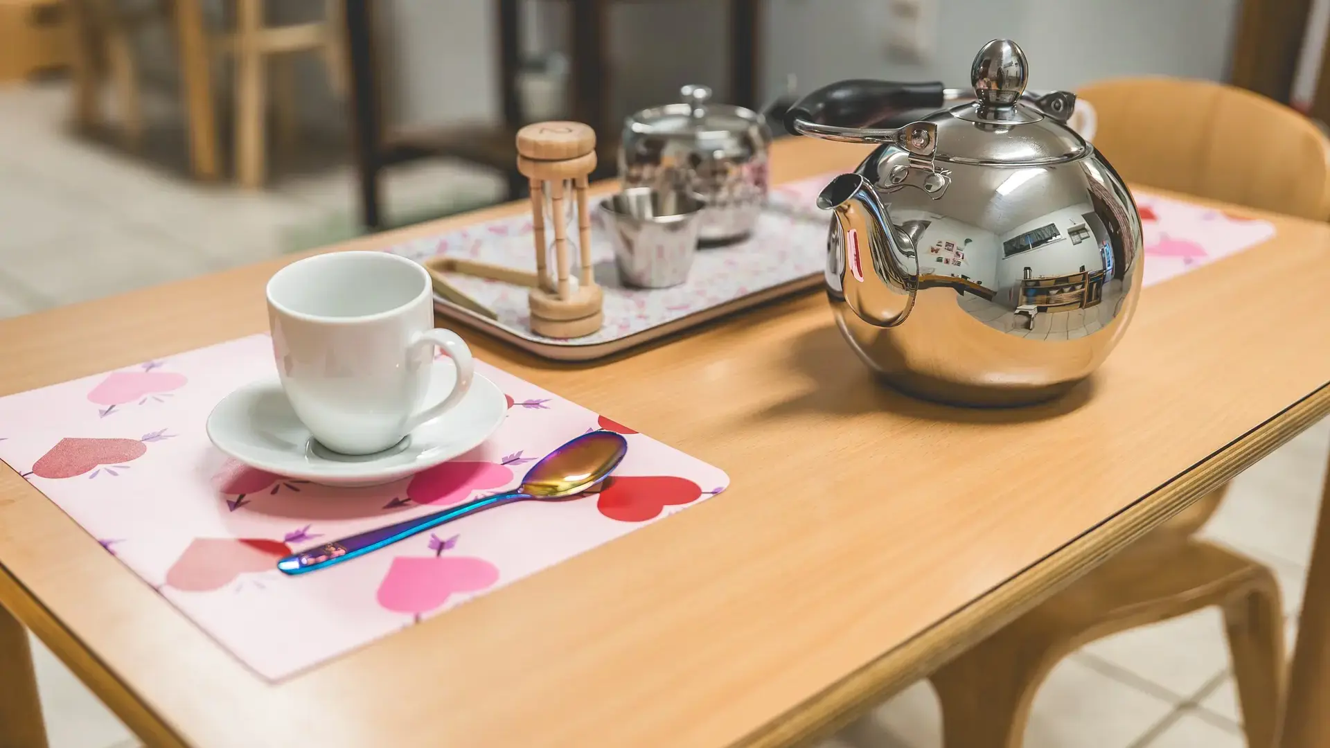 Primary classroom tea set with cup and teapot arranged on a table.