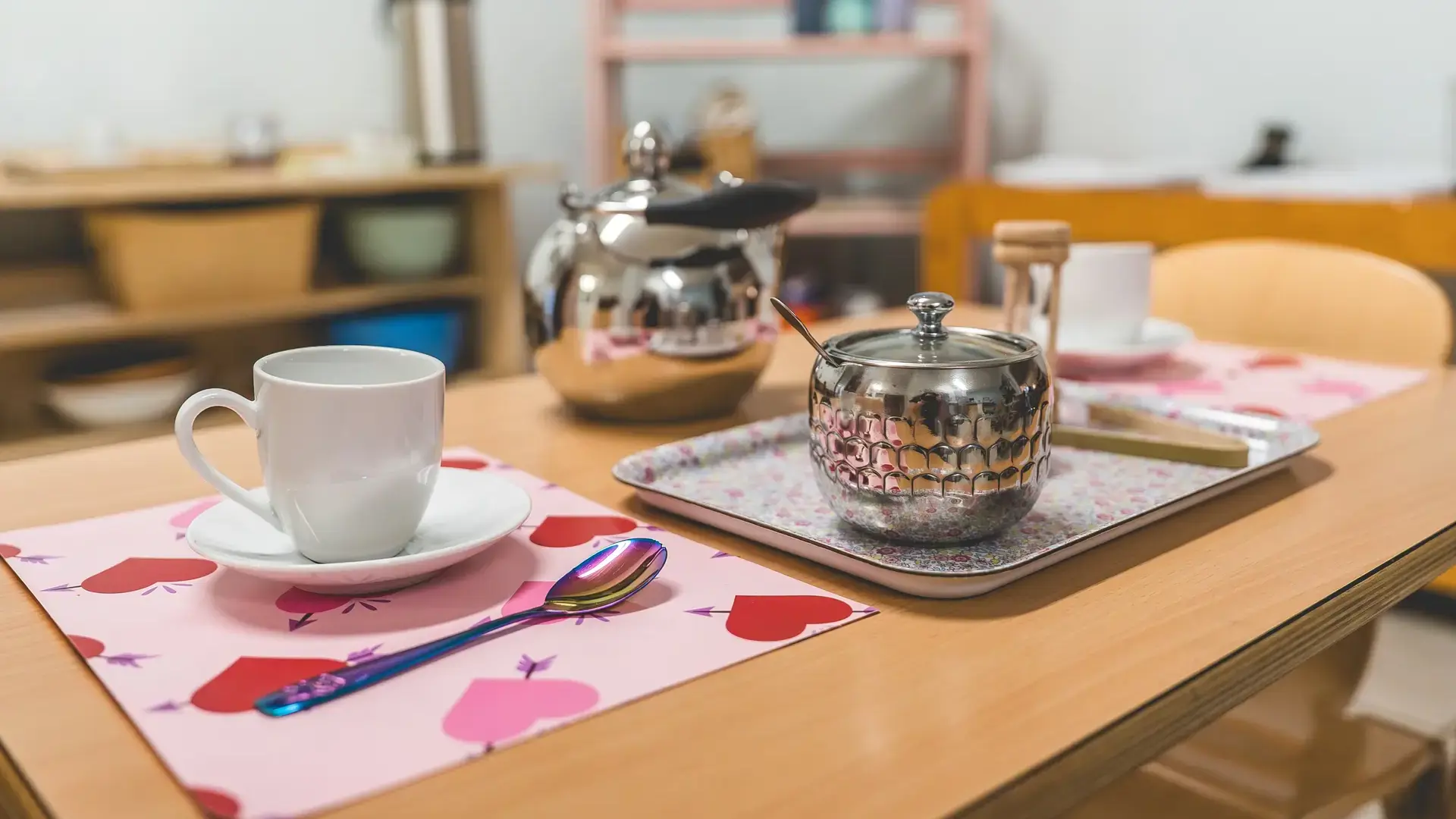 Primary classroom tea set arranged on a table for a practical life activity.